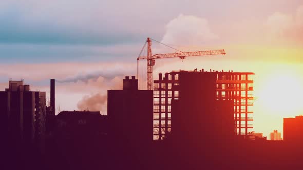 Tower Crane Working on Construction Residential Building Constructors are Working Sunrise or Sunset alt
