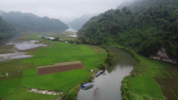 Aerial View of Rice Fields Green Forest Rivers and Mountains in Rural Areas alt
