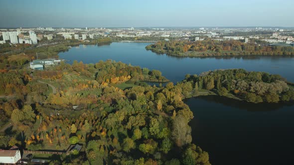 Flight Over The Autumn Park. Park On The Shore Of A Large Lake. alt