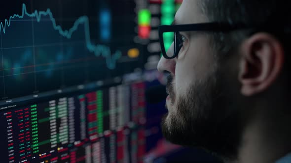 Trader is Working with Multiple Computer Screens Full of Charts and Data Analysis and Stock Broker alt