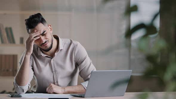 Unhappy Shocked Arabian Male Worker Look at Laptop Screen Feeling Nervous Upset with Bad News alt