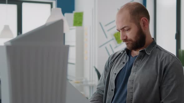 Portrait of Man Architect Analyzing Building Model to Design Urban Construction in Office alt