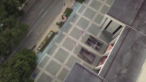 State flags wave outside entrance to State Library and Archives of Florida in Tallahassee. Aerial, h alt