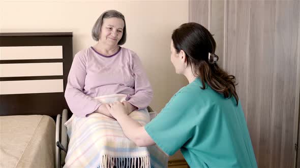 Nurse Talking with Senior Woman in Wheelchair