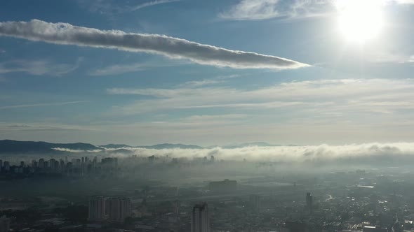 Fog morning at downtown district. Above the clouds. alt