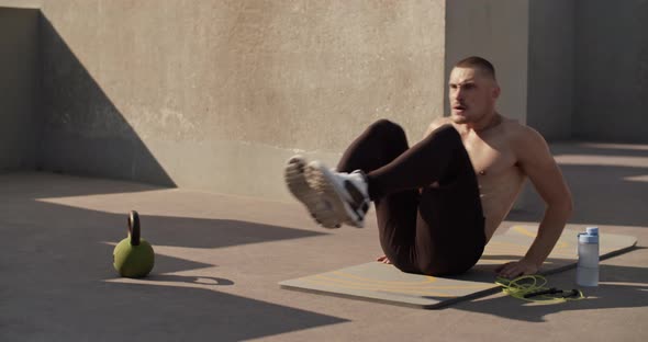 Sportsman Doing Abs Exercise on Sports Ground alt