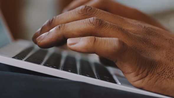Male African American Man Hands Typing on Laptop Keyboard Close Up alt