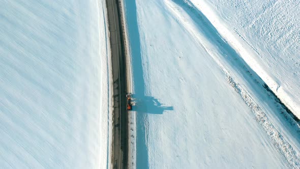Aerial View Snow Removal Tractor Clears Road From Snow alt