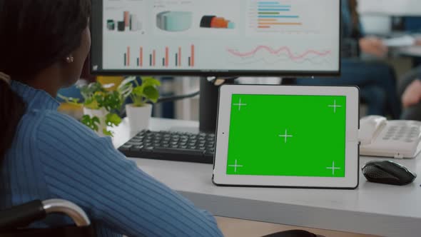 Immobilized African Looking at Digital Tablet with Green Screen alt