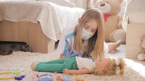Beautiful Little Girl Playing Doctors with Doll at Home alt