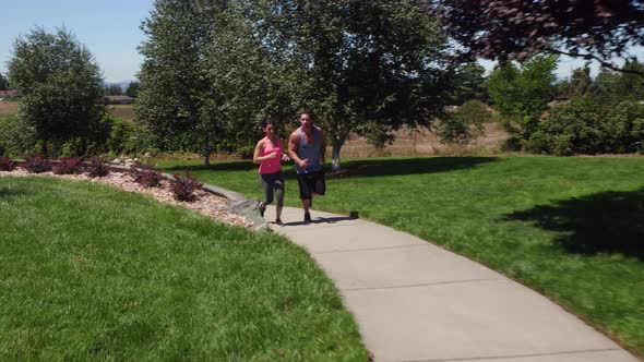Athletic couple running at park
