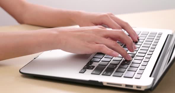 Typing on laptop computer alt