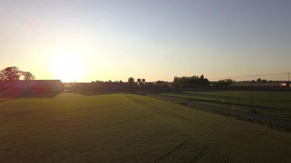 Aerial Cinematic Clip Drone Flying Over a Farm Field During Sunset alt