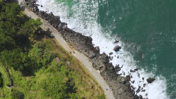 Wavy blue sea and coastal promenade. Jeju Island Olle Trail. Jeju IO