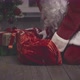 Santa Claus Putting Present Under Christmas Tree - VideoHive Item for Sale