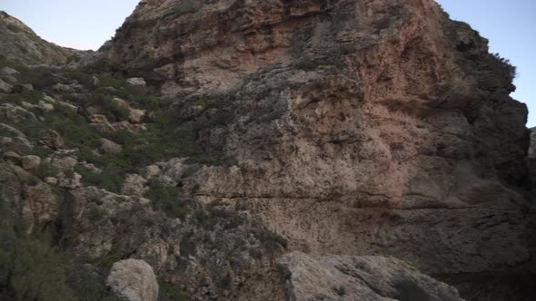 Poor Greenery and Plants Growing on Rocky Steep Hills near Coastline in Malta