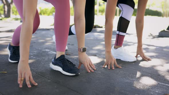 Two Women Preparing for Run in Park alt