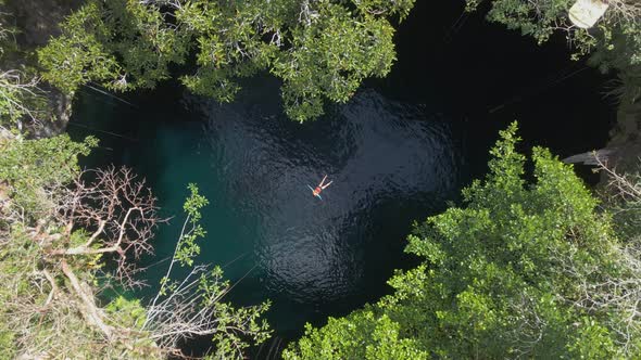 Person Floating in Open Cenote