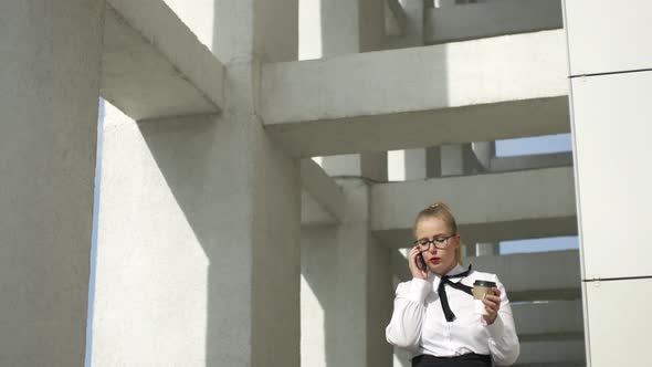 business woman with coffee talking on the phone