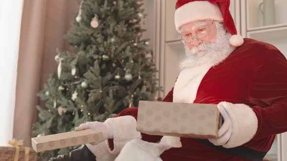 Santa Opening Gift Box Smiling alt