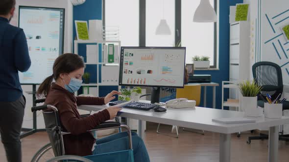 Invalid Businesswoman with Protection Mask Analysing Financial Statistics alt