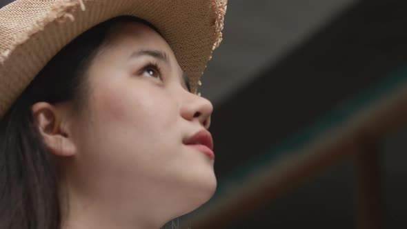 Beautiful young Asian woman looking up, feeling freedom in summer vacation time.