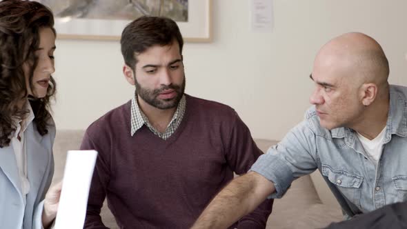 Focused Owners Talking with Interior Designer alt