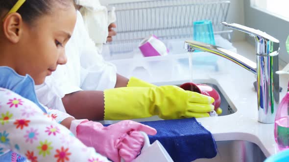 Granny and granddaughter washing up alt
