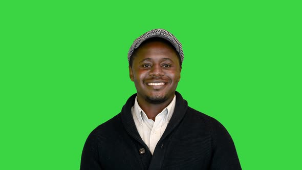 Casual African American Man in a Hat Smiling on a Green Screen Chroma Key alt