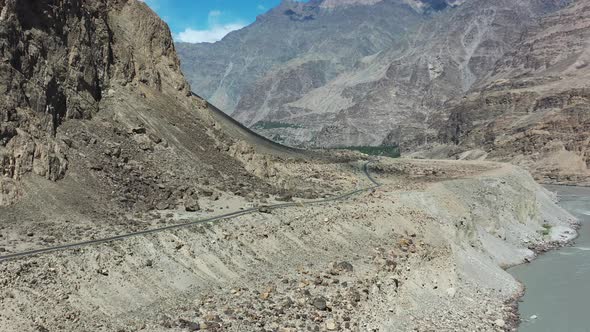 aerial drone flying up over the Indus River Valley as the river flows through the gorge in Skardu Pa alt