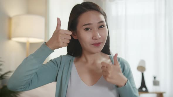 Portrait of Beautiful Asian Woman Showing Thumb up Sign
