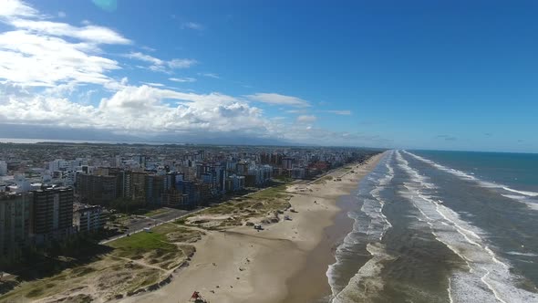 Beach and city, aerial scene in 4k, Capao da canoa city, south of Brazil. alt