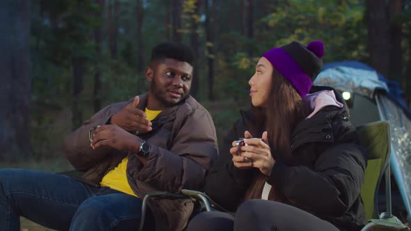 Multiethnic Hiking Couple Relaxing in Camping alt