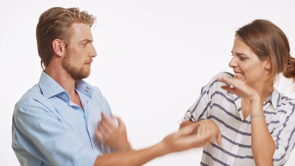 Funny Caucasian Pair Fake Hand Fighting and Smiling on White Background alt