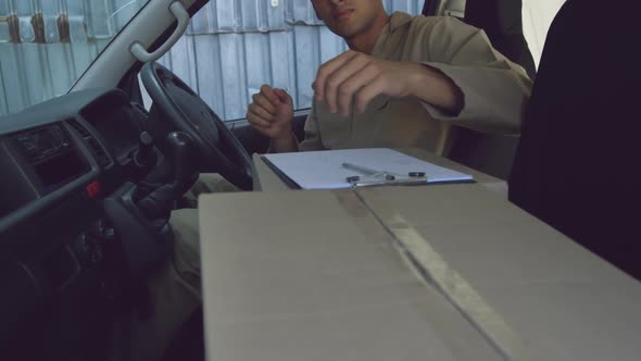 Young male van driver with a warehouse delivery alt