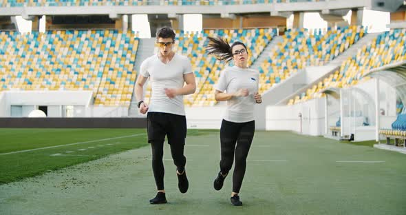 Athletic Couple Finishing Jogging