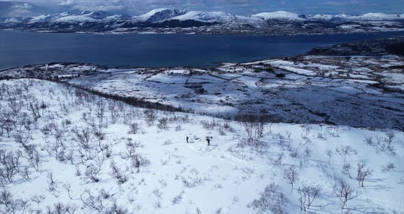 Orbit motion of hikers enjoying the breathtaking landscape on a mountain peak in Sortland with backg alt