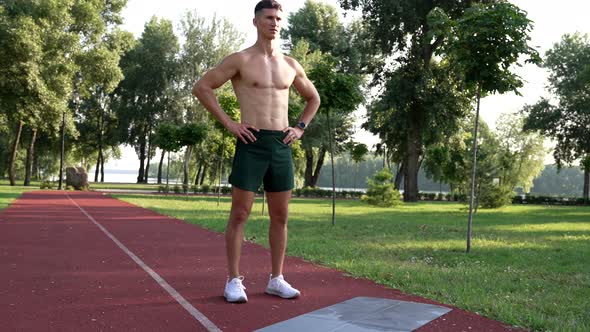 Athletic Man with Muscular Body Ready for Training Outdoor in Park Motivation alt