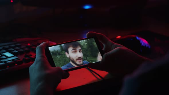 Young adult teenager watching teen vlogger on the phone alt