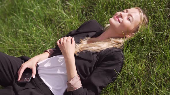 Young Woman Lying on Grass alt