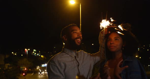 Couple holding sparkles in city 4k alt