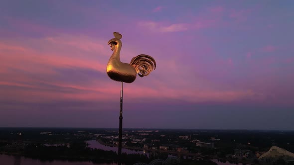 Aerial Close View of Golden Weather Cock or Rooster in Riga Old Town During Amazing Scenic Sunrise alt