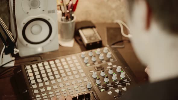 Unrecognizable DJ Creating Music in Retro Home Studio
