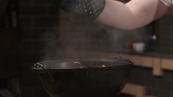 Chef Serves Dishes That Were Cooked in Cauldron or Large Castiron Frying Pan Opens Lids and Aromatic alt