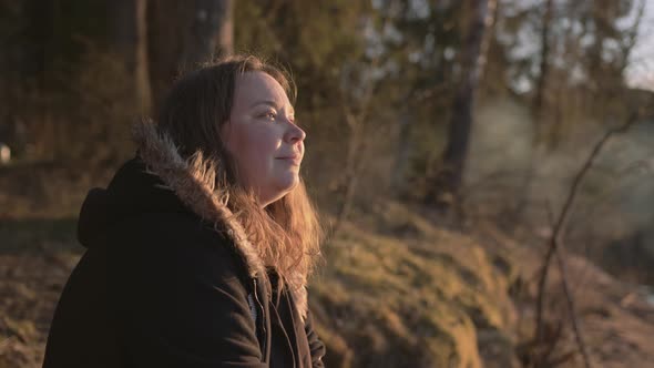 A Young Plump Beautiful Girl at Sunset By the Lake in the Rays of the Sun alt