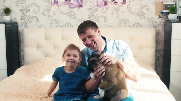 Portrait of father with daughter and puppy