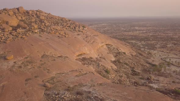 Aerial view of a traditional village in desert at sunset, Angola alt