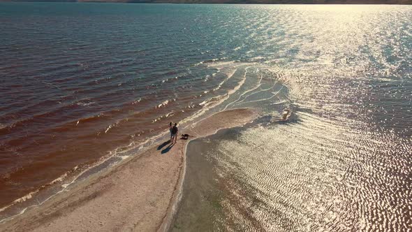 Aerial View Tourist Couple Walking By Sand Bar of Tiligul Landscape Park Mykolaiv Region alt
