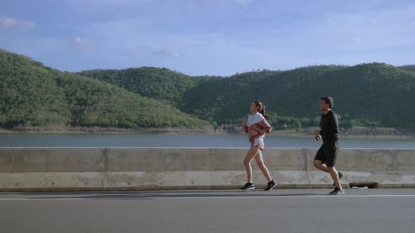 Couple jogging on the street, staying healthy concept
