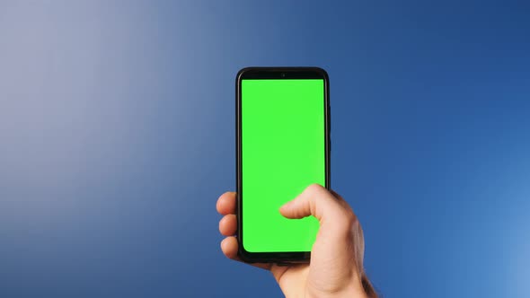 A Young Man with a Modern Smartphone in His Hand Looking at a Mockup Screen with Tracking Markers on alt